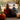 A calendar features images: people relaxing in a pool, colorful autumn leaves, a basket with a bunny and Easter eggs, and a hand holding a snowman ornament with festive lights.