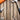 Various hand tools, including a hammer, pliers, adjustable wrench, and screwdriver, are arranged on a wooden surface, with an orange tool box partially visible in the upper left corner.