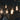 Hanging vintage Edison bulbs illuminate a dim space with exposed brick walls and graffiti art, casting a warm, soft glow.