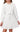 A young girl is wearing the DOKOTOO Kids Girls’ Long Sleeve Textured Belted A-Line Dress in white, featuring subtle vertical stripes and a tied waist belt. Her head is slightly turned and her hands rest comfortably by her sides, perfectly capturing the timeless charm of this DOKOTOO swing dress—an ideal fall dress that girls will love.