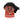 The Disney Princess Moana Bitty Boomer Collectible Bluetooth Speaker by Disney features a compact, stylized design inspired by Moana, showcasing her dark skin, large expressive eyes, wavy black hair swept to the side, red and tan dress, and signature turquoise necklace.