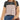 A woman wearing the LOLILRSD Women’s Color Block Long Sleeve Crewneck Tunic Top—featuring a relaxed fit with black, beige, and tan panels—paired with blue jeans, rings, a necklace, and a brown shoulder bag.
