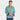 A smiling man in a Goodfellow & Co Men's Reversible Long Sleeve Button-Down Shirt in green and blue jeans stands against a plain white background.