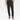 A person wearing the Men’s Tapered Pintuck Fleece Jogger Pants from Goodfellow & Co™ in black, featuring a drawstring waist and side pockets, paired with a dark shirt and gray sneakers, stands against a plain white background.