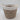 The Bullseye’s Playground™ Natural Woven Wicker Storage Basket - Medium with White Accent Handles showcases a stylish beige and brown pattern, complemented by a white fabric rim and a tag reading “STORAGE BASKET.” Set against a plain white background, this decorative basket is perfect for organizing any room.