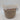 The Bullseye’s Playground™ Natural Woven Wicker Storage Basket - Medium with White Accent Handles showcases a stylish beige and brown pattern, complemented by a white fabric rim and a tag reading “STORAGE BASKET.” Set against a plain white background, this decorative basket is perfect for organizing any room.