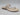 The Vince Camuto Lexiea Women’s Sandal in Panna Creme features a textured, snake print leather strap and a braided toe loop, shown as a single sandal on a white background.