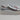 Showcased from the side against a plain light background, the Blondo Women’s Venna Metallic Leather Platform Sneakers in Silver (size 6.5M) feature a silver leather upper, gray laces, and a thick white sole.