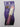 L.A. COLORS Beautifully Bewitched Magical pH Reactive Lip Oil in a sparkly purple tube with a white cap featuring gold star accents, displayed in purple-themed retail packaging.
