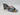 The Drop Pattie Quilted High Block-Heel Mule Sandals in black with a gold-tone accent on the heel.