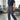A man in a navy short-sleeved button-down shirt and charcoal Red Kap Men’s Pro Pant with MIMIX standing in a workshop.
