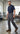 A man in a navy short-sleeved button-down shirt and charcoal Red Kap Men’s Pro Pant with MIMIX standing in a workshop.