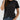 A person wearing a black Women’s Wrinkle-Free Short Sleeve Crew Neck T-Shirt tucked into blue jeans.