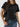 A person wearing a black Women’s Wrinkle-Free Short Sleeve Crew Neck T-Shirt tucked into blue jeans.