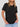 A person wearing a black Women’s Wrinkle-Free Short Sleeve Crew Neck T-Shirt tucked into blue jeans.