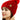 A woman wearing a PAGE ONE Women’s Chunky Cable Knit Pom Pom Beanie in bright red with a matching pom-pom on top.