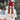 A woman wearing a PAGE ONE Women’s Chunky Cable Knit Pom Pom Beanie in bright red with a matching pom-pom on top.