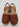 The Kenneth Cole Reaction Women’s Fine Glass Wedge Sandal is a stylish women’s brown open-toe wedge sandal featuring a closed front, open heel, and slingback strap. It showcases matching brown material on the sole and heel with visible stitching along the upper edge.