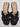 The Women’s Nina Slide Sandals by A New Day, crafted in black leather with an open toe and cutout design, feature a flat tan sole and minimalist style. These slip-on slide sandals evoke effortless charm and are showcased against a plain background.