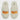 A pair of cream-colored Dluxe by Dearfoams Women’s Halloween Trick or Treat Slippers features fluffy white material and orange embroidered text—“TRICK” on the left slipper and “TREAT” on the right. The Dearfoams brand is visible on each insole. Designed with memory foam and slip-resistant soles, these festive slippers keep you both comfortable and steady.